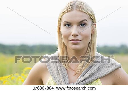 Portrait of young woman in field View Large Photo Image Picture - Portrait of young woman in field. Fotosearch