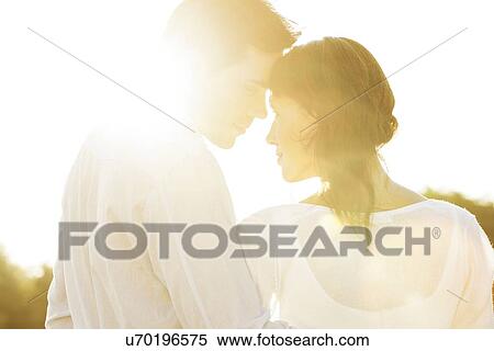 Rear view of romantic couple looking at each other during summer View Large Photo Image Stock Photography - Rear view of romantic couple looking at each other during summer. Fotosearch