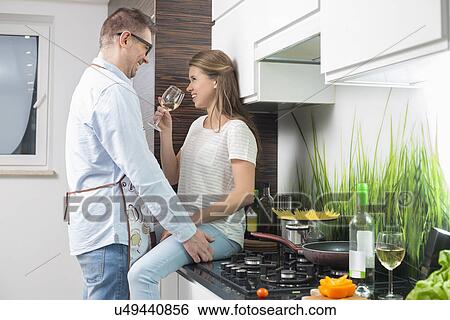 Romantic couple in kitchen View Large Photo Image Stock Photograph - Romantic couple in kitchen. Fotosearch