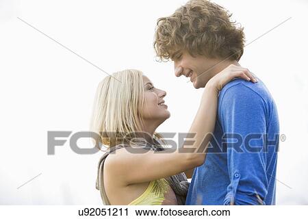 Romantic young couple looking at each other against clear sky View Large Photo Image Stock Image - Romantic young couple looking at each other against clear sky. Fotosearch