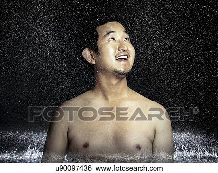 Shirtless young man enjoying rain View Large Photo Image Stock Photograph - Shirtless young man enjoying rain. Fotosearch