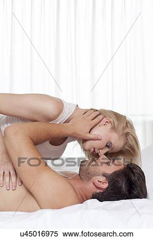 Side view of affectionate young couple in hotel room View Large Photo Image Stock Photography - Side view of affectionate young couple in hotel room. Fotosearch
