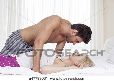 Side view of passionate young couple in bed View Large Photo Image Stock Image - Side view of passionate young couple in bed. Fotosearch