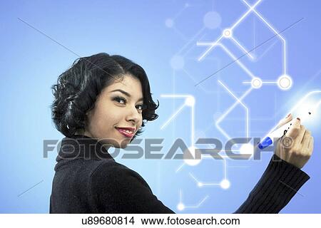 Picture - Side view portrait of smiling businesswoman writing of visual screen. Fotosearch