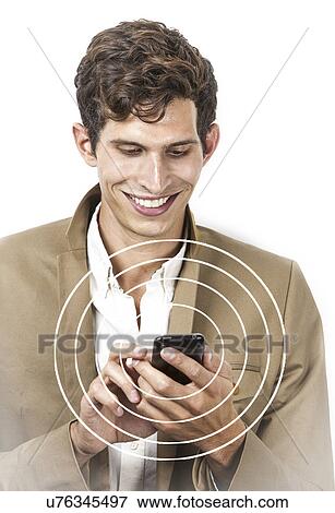 Smiling young businessman using cell phone over white background View Large Photo Image Stock Photo - Smiling young businessman using cell phone over white background. Fotosearch