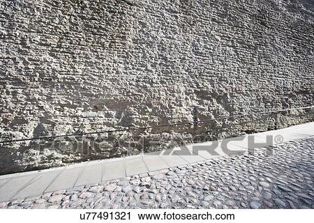 Stock Image - Stone wall and cobblestone street, Tallinn, Estonia, Europe. Fotosearch