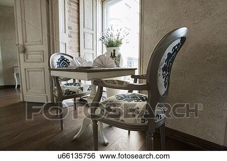 Table and chairs arranged in restaurant View Large Photo Image Stock Photograph - Table and chairs arranged in restaurant. Fotosearch
