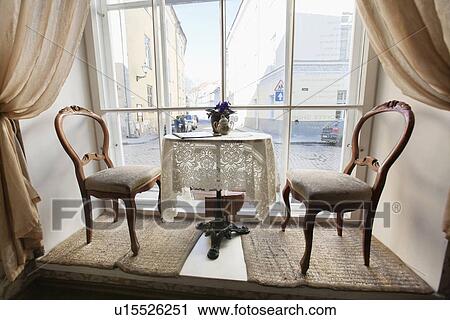 Table and chairs by window in empty cafe View Large Photo Image Stock Image - Table and chairs by window in empty cafe. Fotosearch