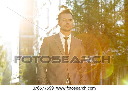 Stock Photo - Thoughtful businessman looking away outdoors. Fotosearch