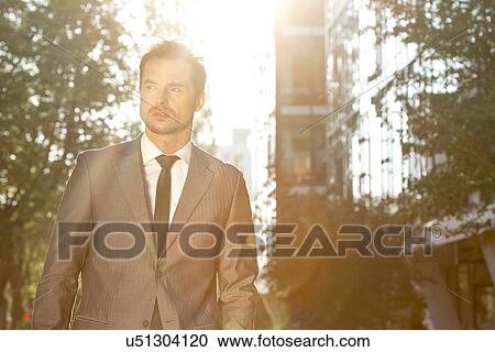 Stock Image - Thoughtful businessman outdoors. Fotosearch