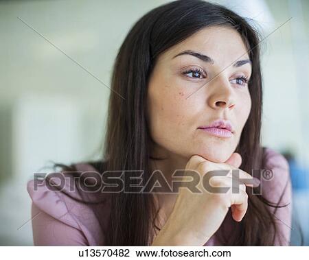 Thoughtful young businesswoman looking away in office View Large Photo Image Stock Image - Thoughtful young businesswoman looking away in office. Fotosearch
