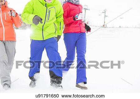 Three young friends running in snow View Large Photo Image Stock Image - Three young friends running in snow. Fotosearch