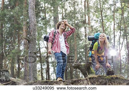 Tired young hiking couple taking a break in forest View Large Photo Image Stock Photography - Tired young hiking couple taking a break in forest. Fotosearch