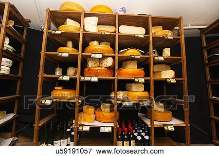 Stock Photo - Variety of cheese in shelves at store. Fotosearch
