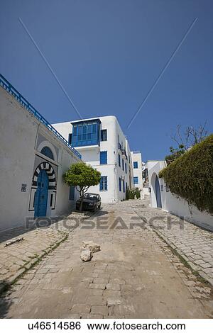 View of street and residential building against clear blue sky, Tunis, Tunisia View Large Photo Image Stock Photograph - View of street and residential building against clear blue sky, Tunis, Tunisia. Fotosearch