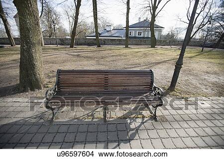 Wooden bench on path in park, Tallinn, Estonia, Europe View Large Photo Image Picture - Wooden bench on path in park, Tallinn, Estonia, Europe. Fotosearch