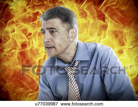 Worried businessman with fire in background View Large Photo Image Stock Photo - Worried businessman with fire in background. Fotosearch