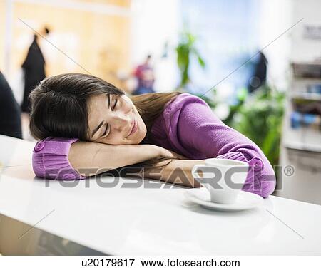 Young businesswoman sleeping at desk in office View Large Photo Image Stock Photo - Young businesswoman sleeping at desk in office. Fotosearch