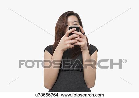 Young businesswoman using smart phone over white background View Large Photo Image Picture - Young businesswoman using smart phone over white background. Fotosearch