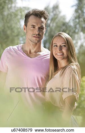 Young couple spending quality time in park View Large Photo Image Stock Photo - Young couple spending quality time in park. Fotosearch