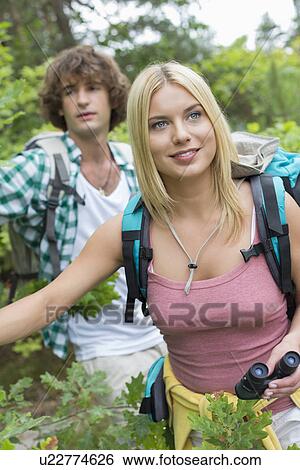 Young hiking couple in forest View Large Photo Image Stock Photograph - Young hiking couple in forest. Fotosearch