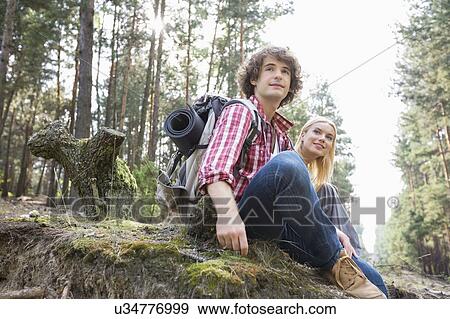 Young hiking couple relaxing in forest View Large Photo Image Stock Photo - Young hiking couple relaxing in forest. Fotosearch