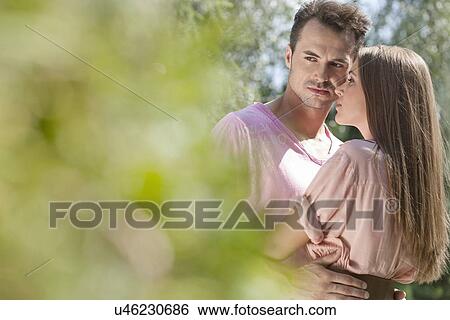 Stock Photograph - Young loving couple spending quality time in park. Fotosearch