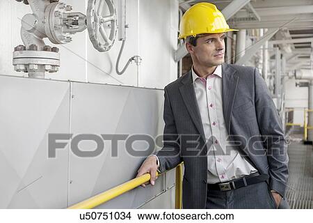 Young male architect in hand hat at industry View Large Photo Image Picture - Young male architect in hand hat at industry. Fotosearch