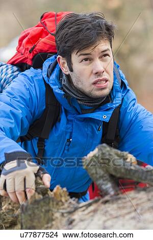 Picture - Young male backpacker hiking in forest. Fotosearch