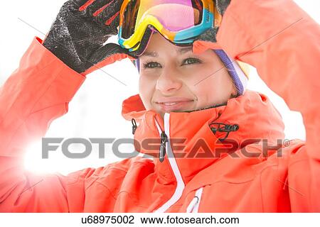 Young woman wearing ski goggles outdoors View Large Photo Image Stock Image - Young woman wearing ski goggles outdoors. Fotosearch