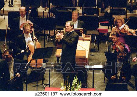 Stock Photo - Stock photo of a conductor leading an orchestra. Fotosearch