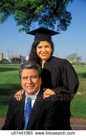 Stock Image - Stock photo of a girl with her father at her graduation. Fotosearch