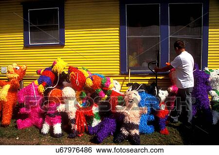 Stock photo of a man moving pinatas outside of the Farmer's Market in Houston Texas View Large Photo Image Stock Photograph - Stock photo of a man moving pinatas outside of the Farmer's Market in Houston Texas. Fotosearch