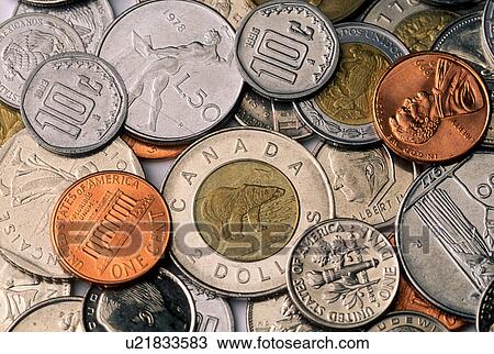 Stock Image - Stock photo of a mixture of American and foreign coins. Fotosearch