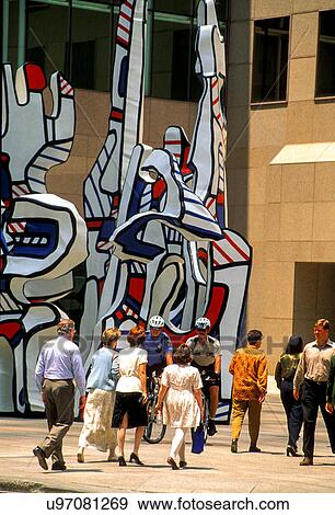 Stock Photo - Stock photo of business people in Houston Texas walking past downtown sculpture "Monument Au Fantome" by Jean Dubuffet.. Fotosearch