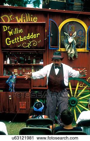 Stock Image - Stock photo of Dr. Willie Gettbedder entertains a group of kids at the Texas Gatorfest in Anhuac.. Fotosearch