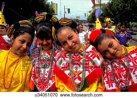 Stock Image - Stock photo of four young girls dressed in typical Mexican costumes for the Cinco de Mayo parade in downtown Houston Texas. Fotosearch