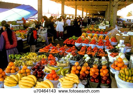 Stock Image - Stock photo of people buying fresh fruit and other produce at the farmer's market in downtown Houston Texas. Fotosearch
