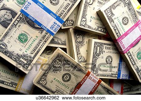 Stock photo of piles of paper currency in different denominations. View Large Photo Image Stock Image - Stock photo of piles of paper currency in different denominations.. Fotosearch