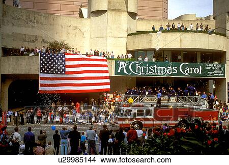 Picture - Stock photo of spectators enjoying a parade travelling through the theater district in downtown Houston Texas. Fotosearch