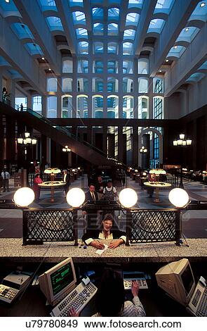 Stock Photo - Stock photo of the interior of a bank building with a customer at the bank teller's desk. Fotosearch