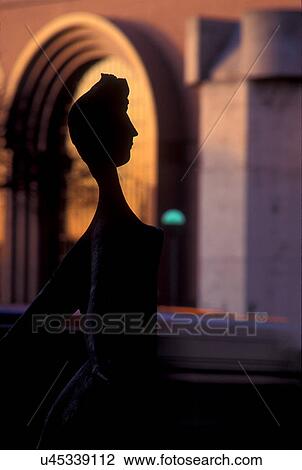 Stock photo of the silhouette of a sculpture against the sun setting on an old styled wall View Large Photo Image Stock Image - Stock photo of the silhouette of a sculpture against the sun setting on an old styled wall. Fotosearch