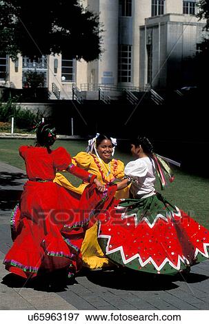 Stock Photo - Stock photo of three young girls dancing in traditional Mexican dresses during the Cinco de Mayo celebrations in downtown Houston Texas. Fotosearch