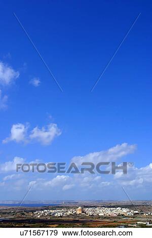 Stock Photo - Blue sky over a village. Fotosearch