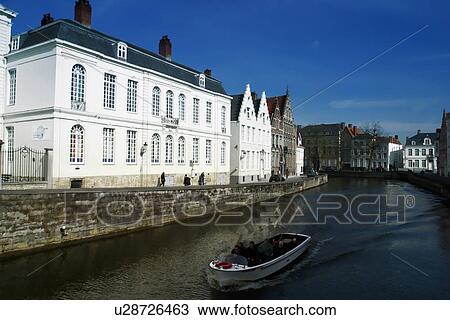 Boat in a river next to a building View Large Photo Image Stock Image - Boat in a river next to a building . Fotosearch