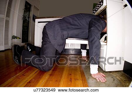 Businessman with his head in an oven View Large Photo Image Stock Photo - Businessman with his head in an oven . Fotosearch