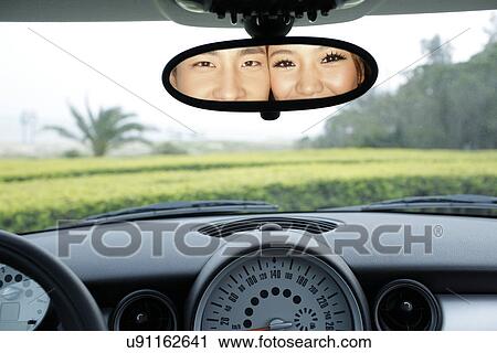 Couple in a rear view mirror View Large Photo Image Stock Image - Couple in a rear view mirror . Fotosearch