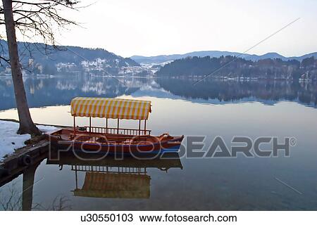 Stock Image - Covered boat in a lake . Fotosearch