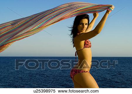 Stock Photography - Holding fabric over her head. Fotosearch