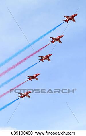 Stock Image - Jets with red and blue smoke . Fotosearch